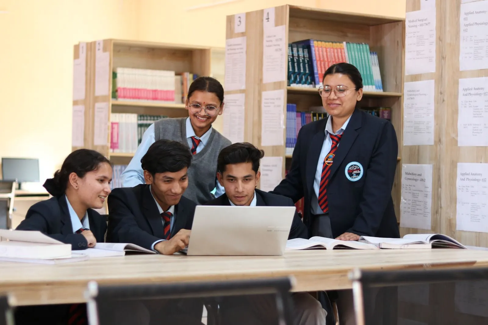 BCA students working together on a project with a faculty member
